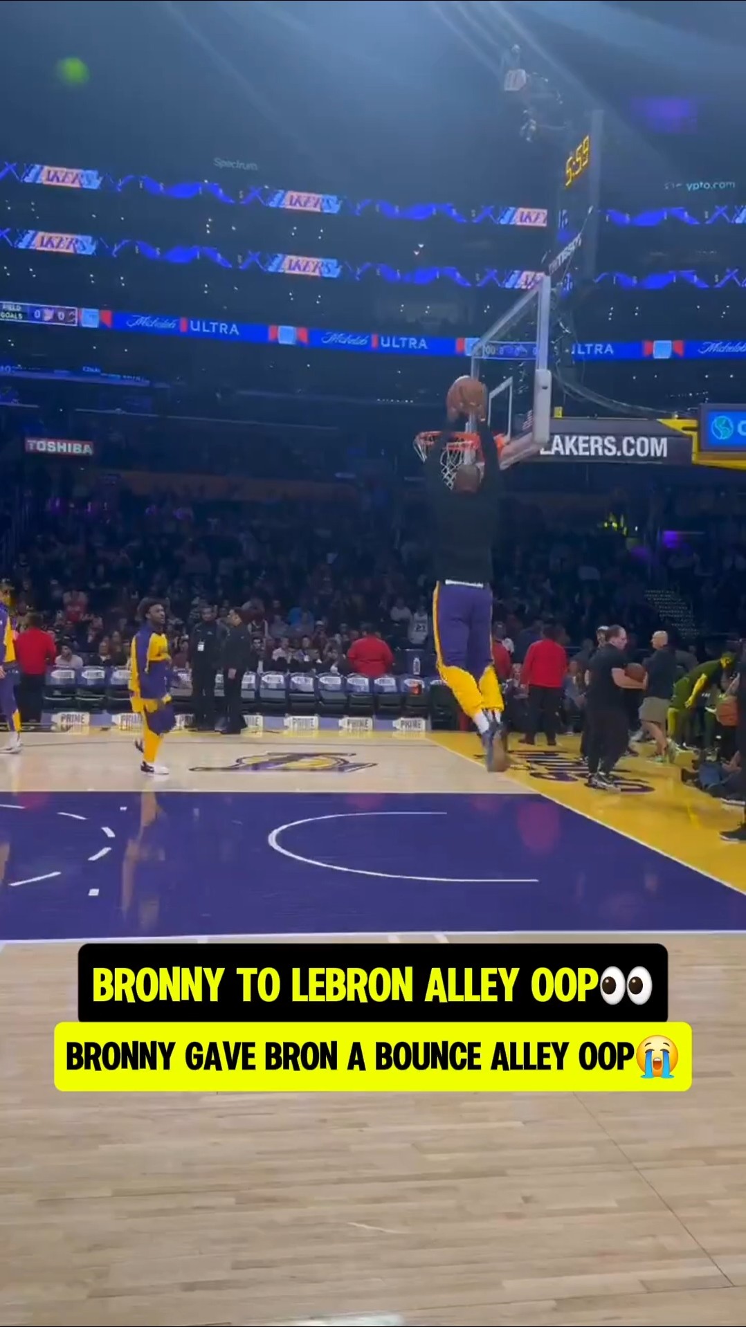 Bronny helping LeBron warm up?