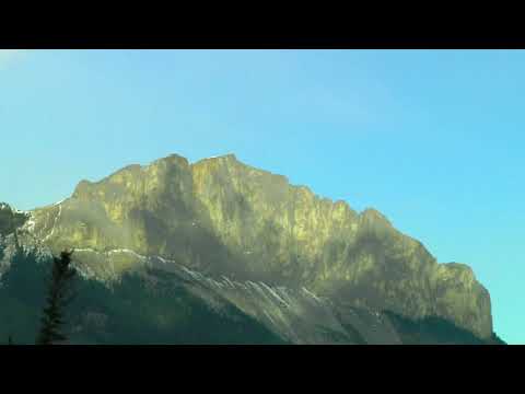 Aerovision -- Passing Clouds Paint Shadowy Portraits on Rocky Mountain Peak