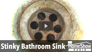 What causes a sewer gas smell to come out of my bathroom sink