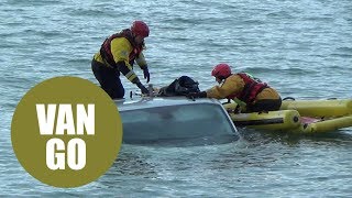 A van is completely submerged by the tide after parked on beach