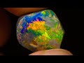 $20k gem black opal emerges from this uncut rough opal