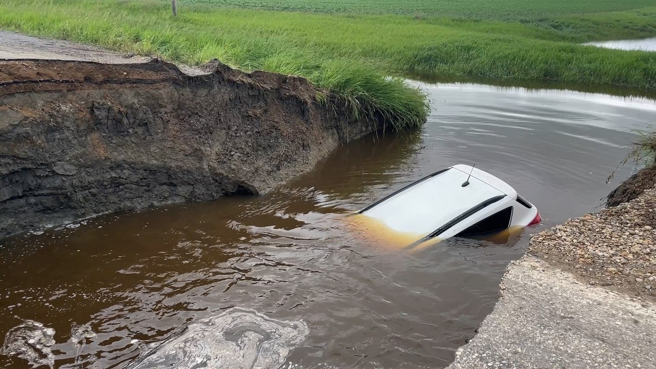 People clean up after heavy rainfall washes out roads, floods towns in ...