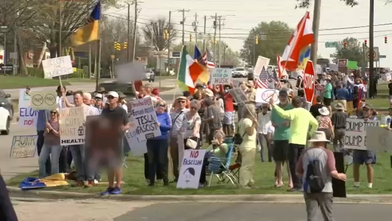 Hundreds gather outside Raleigh Tesla dealership to protest Elon Musk ...