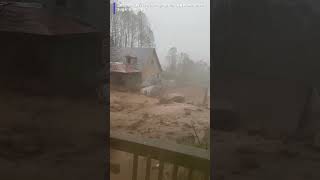 wall of water and mud rushing down a hillside