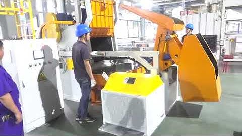 Automatic loading and uploading tumble belt shot blasting machine