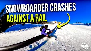 Snowboarder Crashes Against a Rail Attempting a Trick While Holding a Selfie Stick