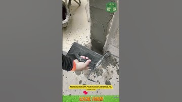 A worker is leveling cement mixture on the wall using a special tool.