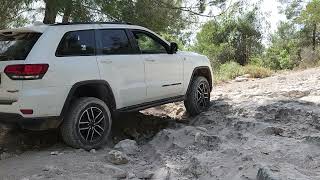 Grand Cherokee Trailhawk climbing up a powdercovered rocky sloap