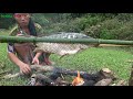 Survival skills  primitive life fishing skills on the river and cooking fish  eating delicious