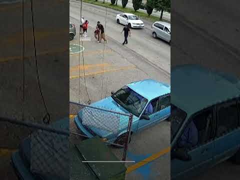 Moment shop worker dives into traffic to save child