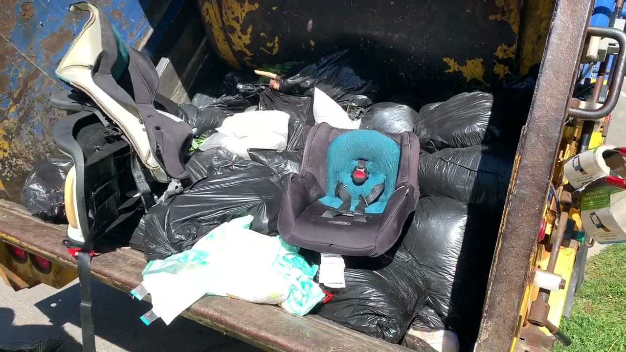 Rear load garbage truck packing bulk with some ￼ diapers