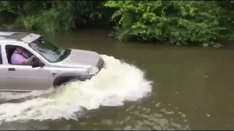 Freelander driving through a ford