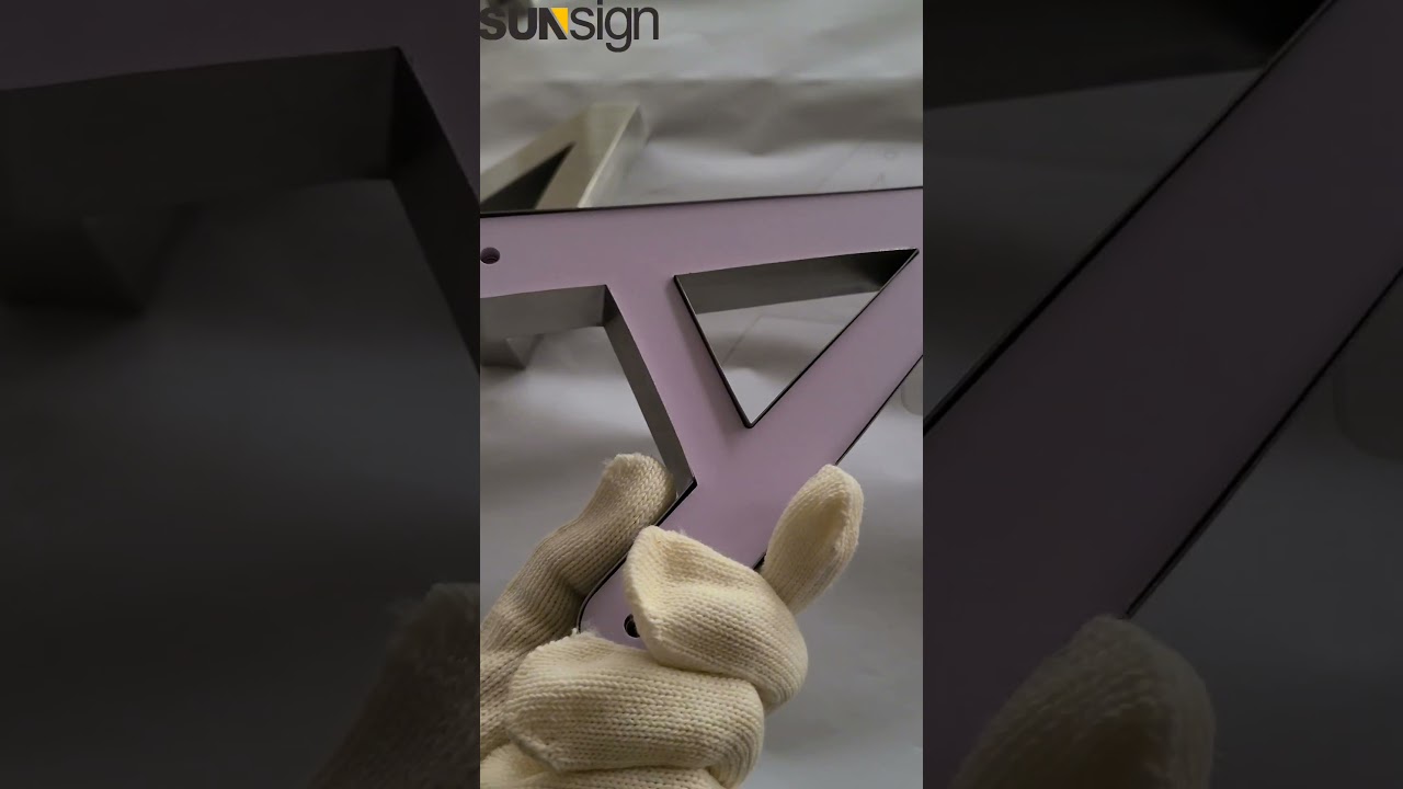 Custom non-illuminated reverse stainless steel channel letters with a brushed finish