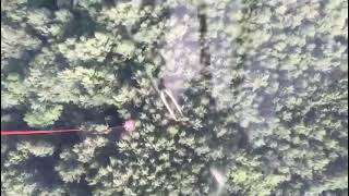 Dropping a bucket of water on a forest fire by helicopter
