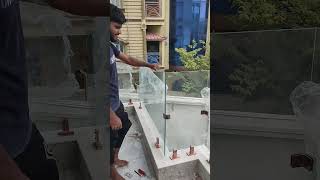 Toughened glass balcony railing frameless with rose gold fittings.