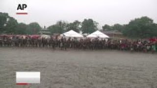 Hundreds of children got to play in a giant pit of mud at the 27th annual Mud Day event in suburban