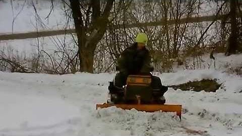 struck mini dozer with hydraulics pushing snow and ice