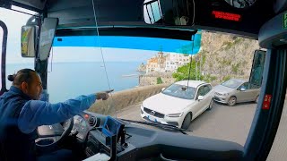 Bus drive narrow cliff road, Italy