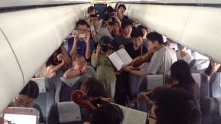 Philadelphia Orchestra musicians perform on flight waiting on Beijing tarmac