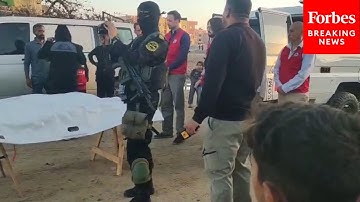 Armed Hamas Members Return Remains Said To Be Of Deceased Hostage To Red Cross