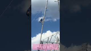 Construction Work: Worker Climbing High Iron Tower for Maintenance