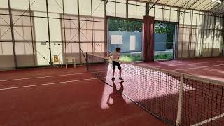 Bewegingen oefenen met een 1kg bal samen met de tennisleraar.