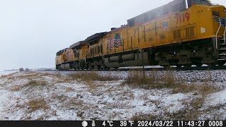 Northbound UP train with BN coal hoppers in the snow on the Spine Line