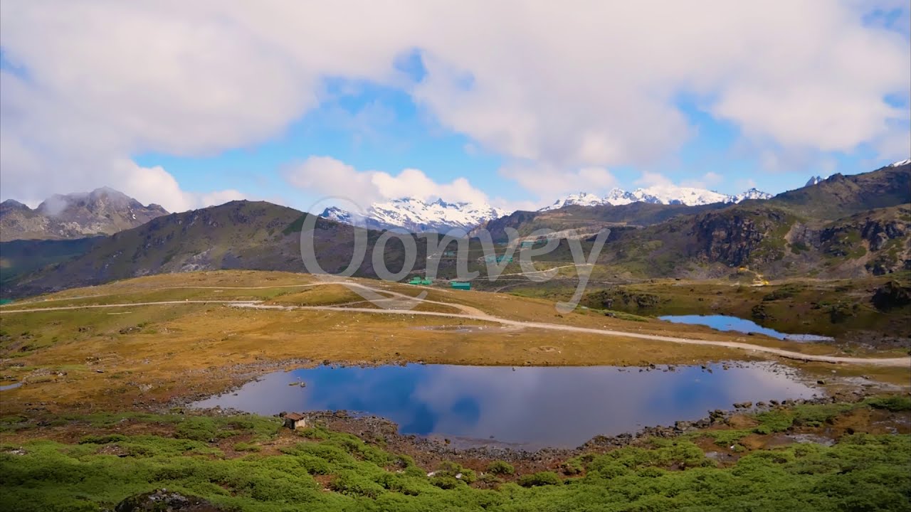 Meadows lakes snow peaks Mountains clouds timelapse huts India | Stock Video | Qonvey