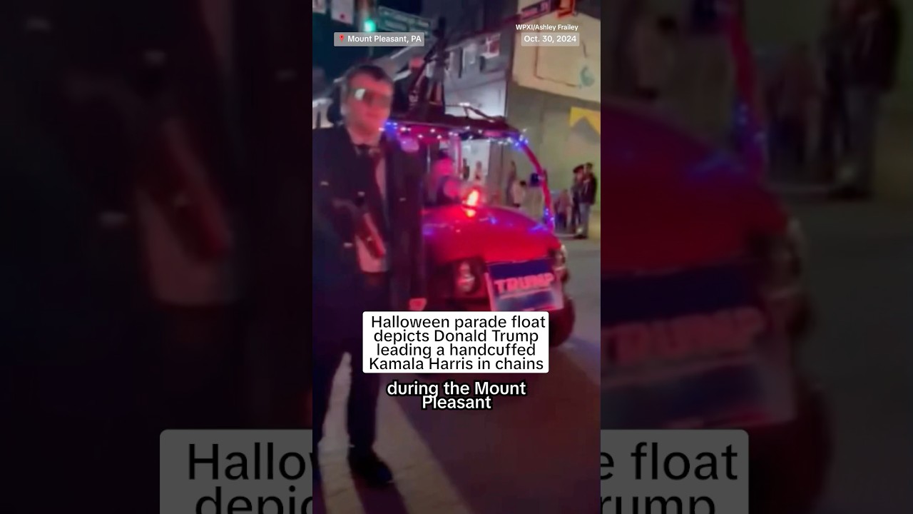 Halloween parade float depicts Donald Trump leading a handcuffed Kamala Harris in chains￼