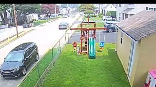 Kid walks in front of girl on swing set then gets kicked in backyard (Security camera)