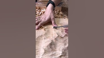 The process of carving textured patterns into wood with a chisel