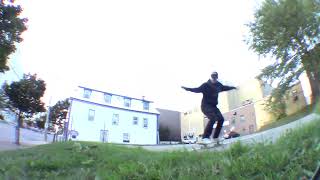 Skateboarder attempts to ollie grass gap then lands on the back of his head