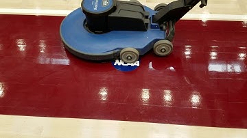 WAXIE demo helping educate on maintenance of a NCAA gym floor