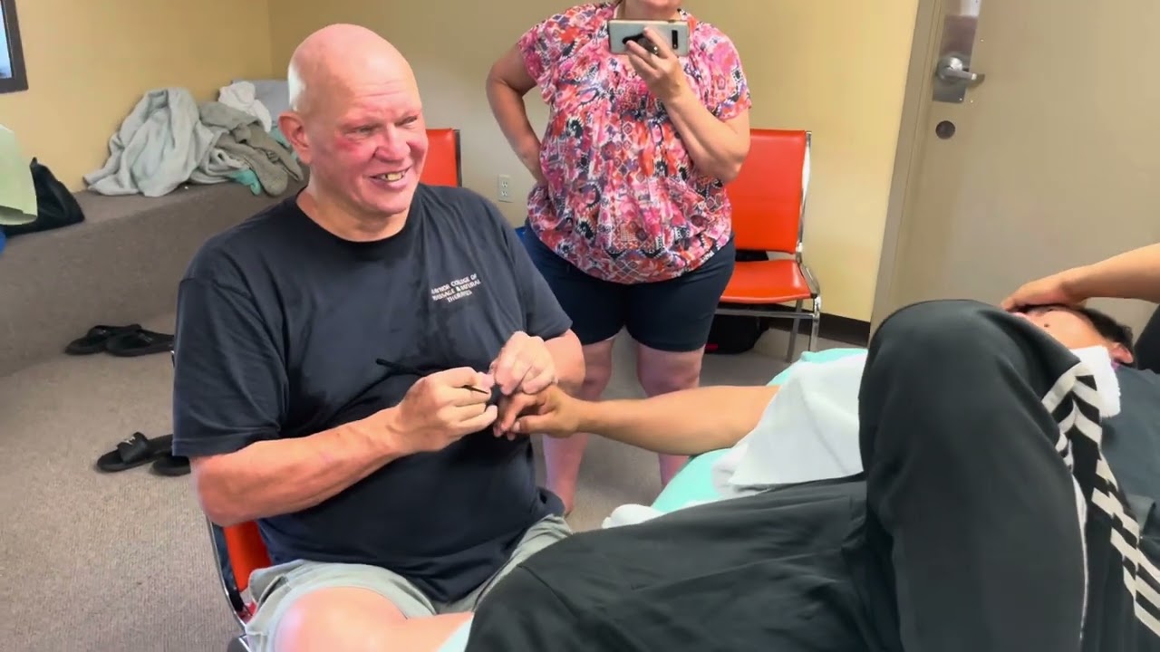 Raynor hand massage using masssge tools.