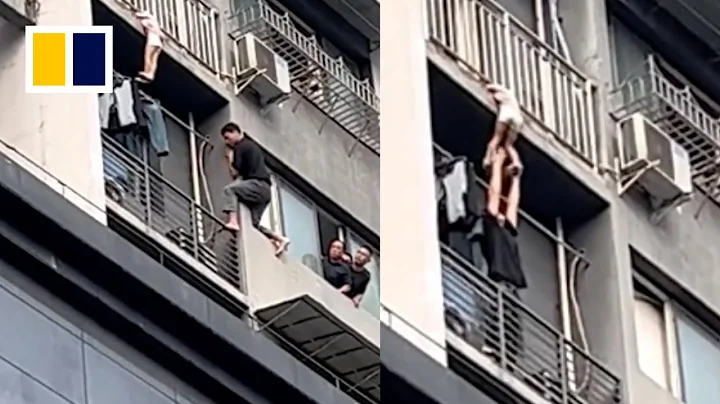 Heroic man holds up child dangling from balcony - DayDayNews