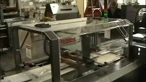 High speed shrink wrapping of video discs