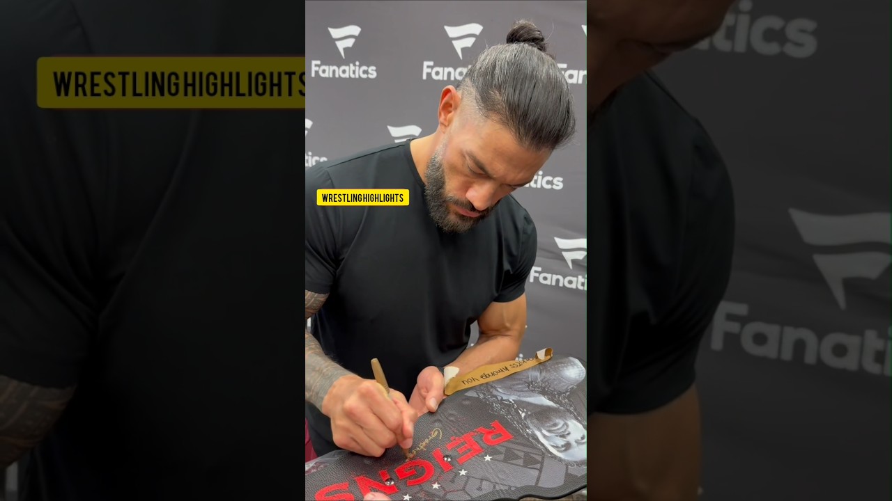 Roman Reigns signing his Tribal Chief belt