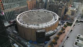 Aerial view of famous Madison Square Garden surrounded by tall buildings in urban borough. New York