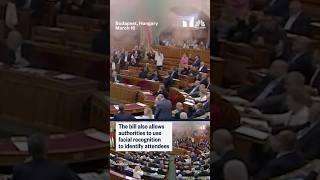 Hungarian lawmakers light flares in opposition to a bill that bans Pride events
