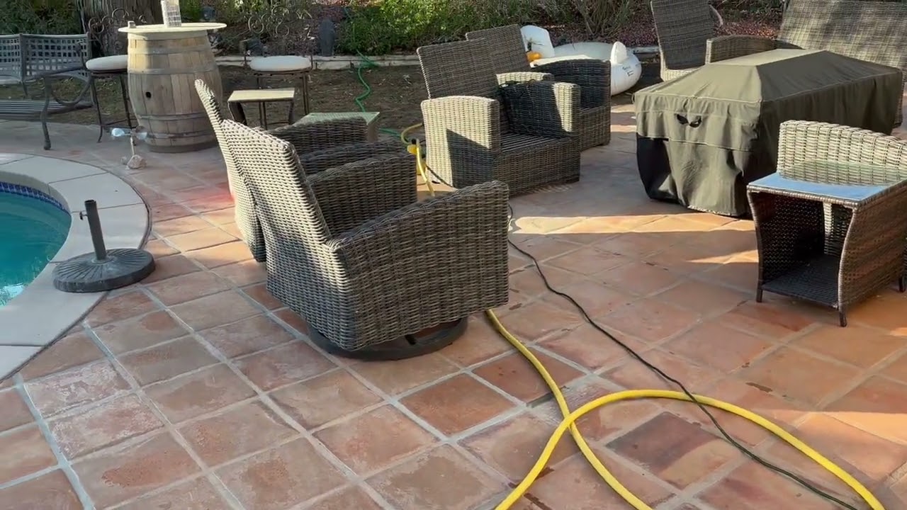 Blowing and Cleaning outdoor area with water
