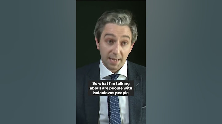 Simon Harris reacts to migrant protesters wearing "balaclavas" & "brandishing" the Irish tricolour