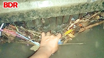 Remove Trash And Debris Clogged Drain On Street Road After Rain