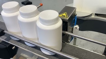 Labelling system for wrap-around label application onto plastic jars.