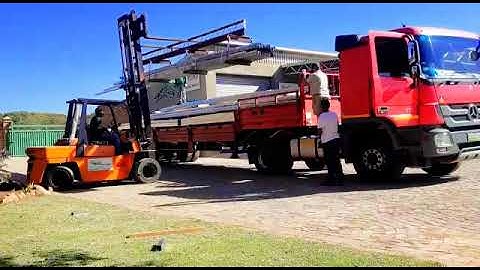 Time Lapse of how a semi is loaded with roof trusses using a forklift.