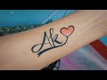 Drawing temporary tattoo of a k letter tattoo with pen  ak couple letter tattoo design ideas