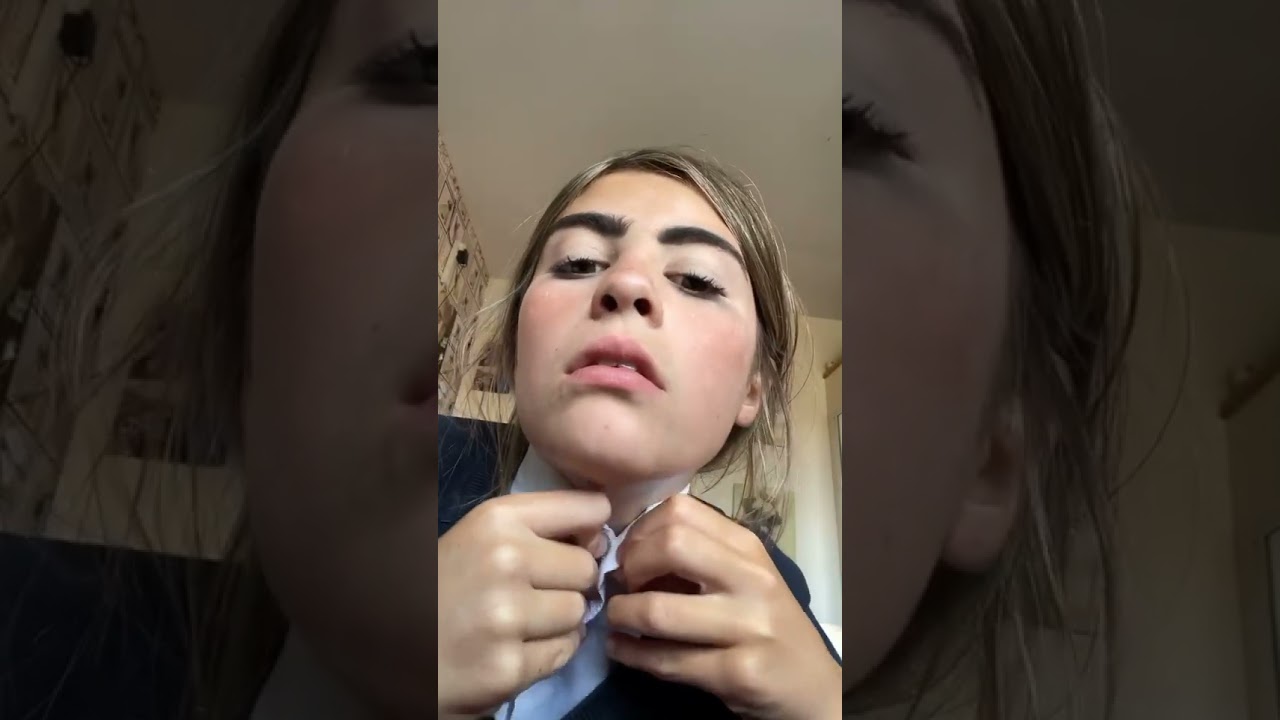 Katie shows us what it looks like with her top collar button undone. She prefers hers fastened up