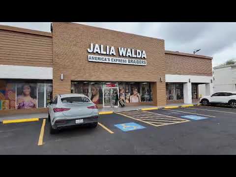 The Jalia Walda Salon storefront on Hillcroft in Houston seen from the parking lot, with the JALIA WALDA sign above the windows
