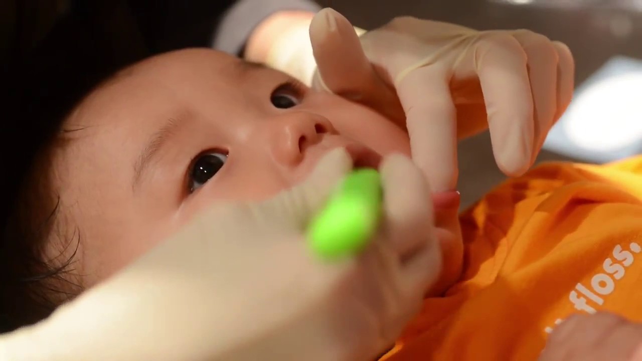 How to brush baby teeth in knee to knee position 720p YouTube