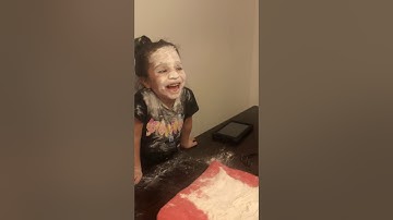 Dad and daughter playing Rock, Paper, Scissors and loser has to put their face in flour.