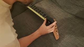 How do you measure the scale length on a guitar?
